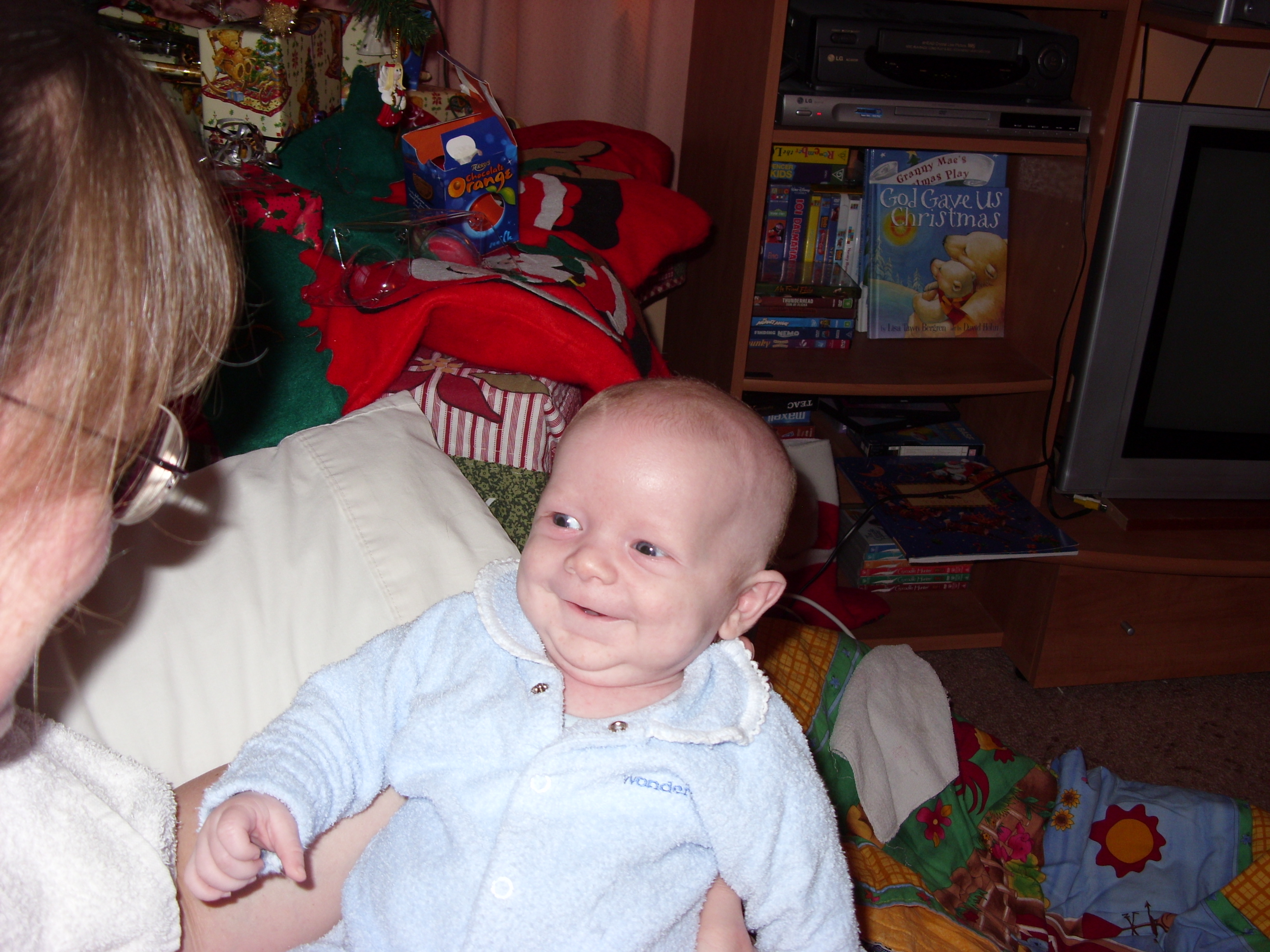 Alex smiling at his mum on his first Christmas