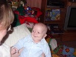 Alex smiling at his mum on his first Christmas